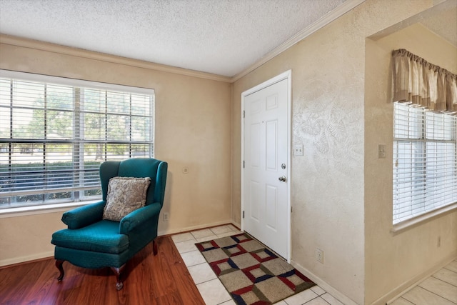 foyer featuring a wealth of natural light, light tile patterned flooring, and a textured ceiling