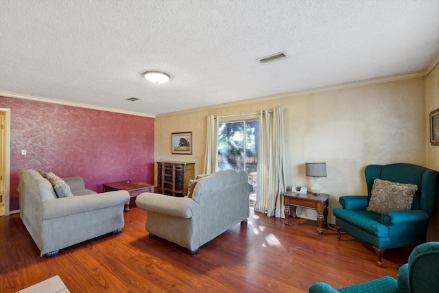 living room featuring hardwood / wood-style flooring, crown molding, and a textured ceiling