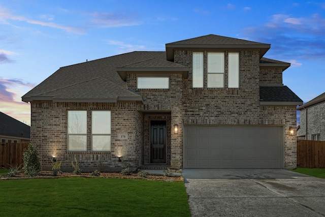 view of front of house featuring a lawn and a garage