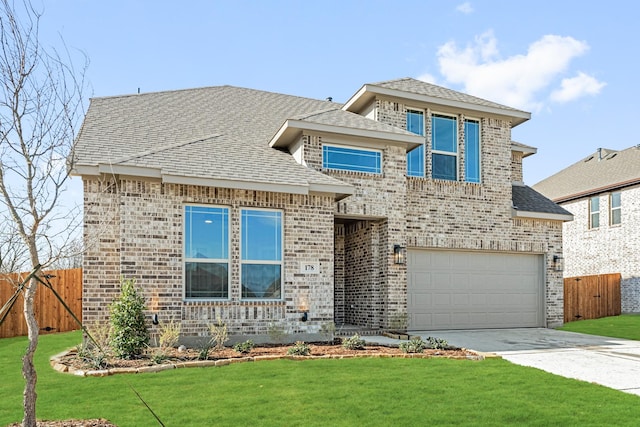 view of front of house with a front lawn and a garage