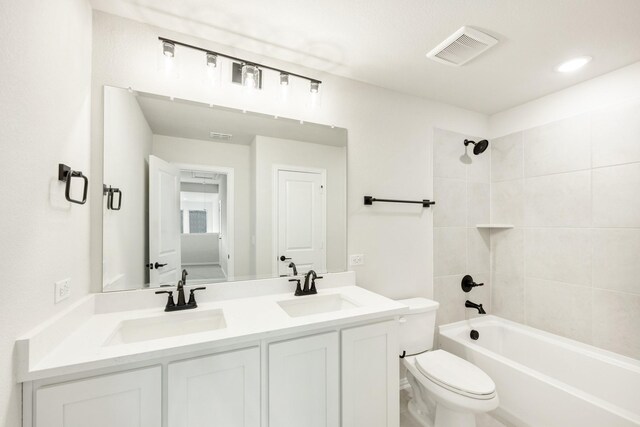 full bathroom featuring shower / bath combo, vanity, and toilet