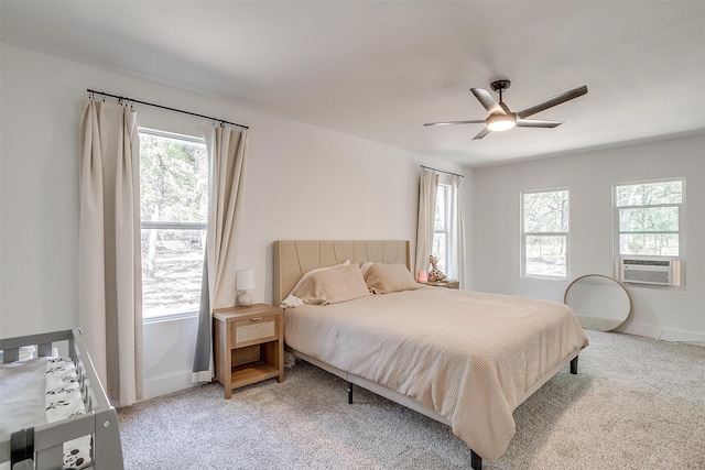 carpeted bedroom with ceiling fan and cooling unit