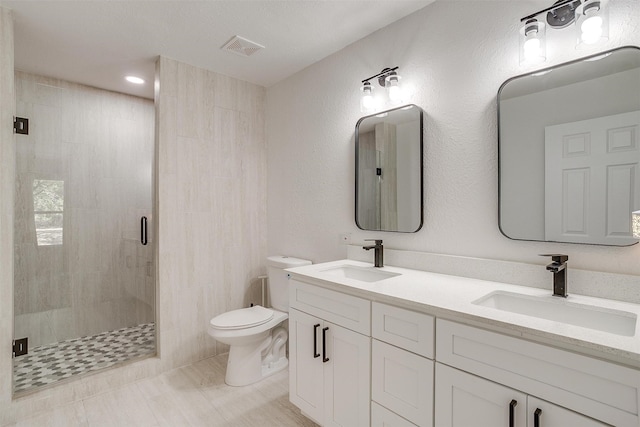 bathroom featuring tile patterned floors, walk in shower, vanity, and toilet