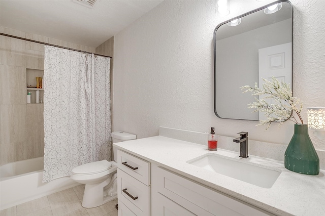 full bathroom featuring vanity, shower / bath combo with shower curtain, toilet, and tile patterned floors