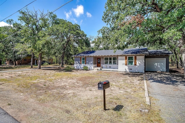 ranch-style home with a garage and a porch