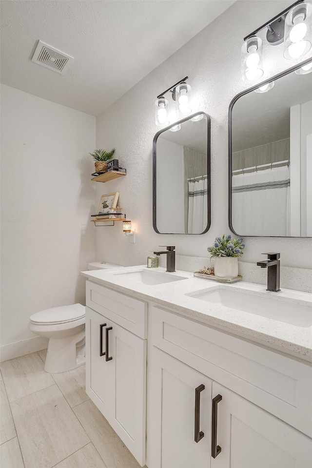 bathroom with vanity, a textured ceiling, tile patterned floors, toilet, and a shower with shower curtain