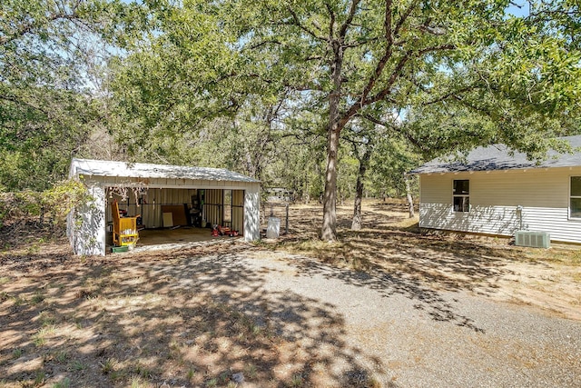 view of yard with an outbuilding and central AC unit