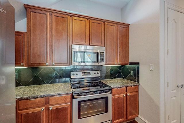 kitchen featuring dark stone counters, backsplash, and appliances with stainless steel finishes