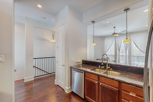 kitchen featuring decorative light fixtures, dark hardwood / wood-style flooring, sink, stainless steel dishwasher, and ceiling fan