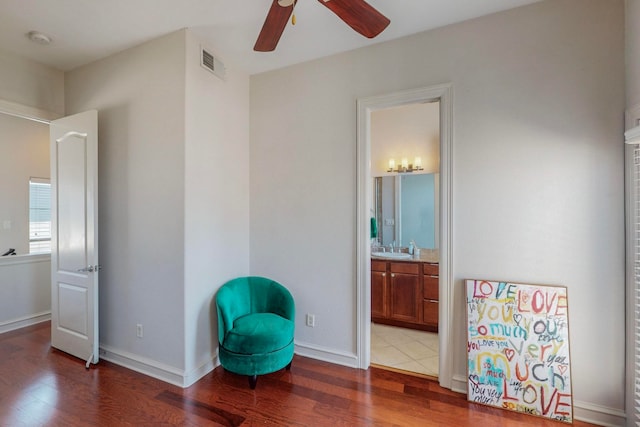 sitting room with sink, wood-type flooring, and ceiling fan