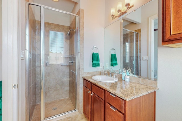 bathroom with walk in shower and vanity