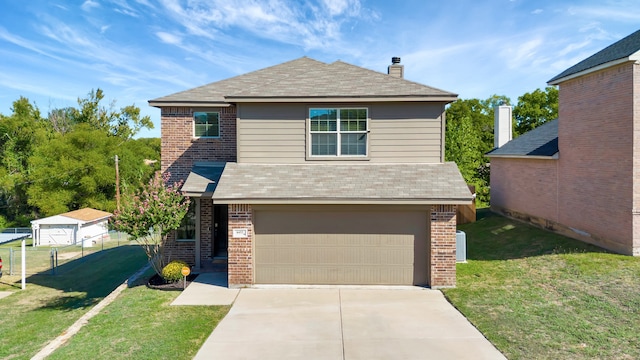 view of front of home with a front yard and a garage