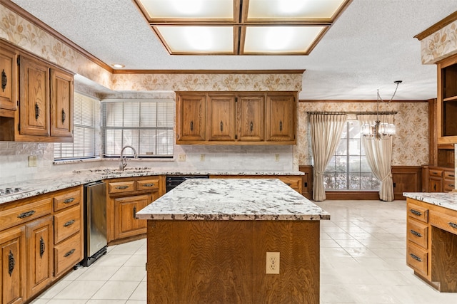 kitchen featuring a textured ceiling, light tile patterned floors, an inviting chandelier, a center island, and hanging light fixtures