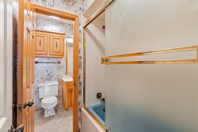 full bathroom featuring vanity, toilet, and bath / shower combo with glass door