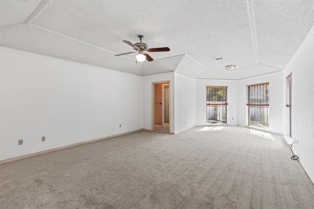 carpeted spare room featuring ceiling fan and a textured ceiling