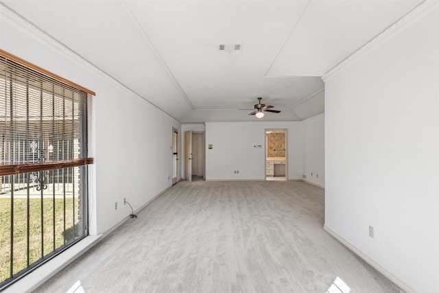 carpeted spare room featuring ceiling fan, lofted ceiling, and crown molding