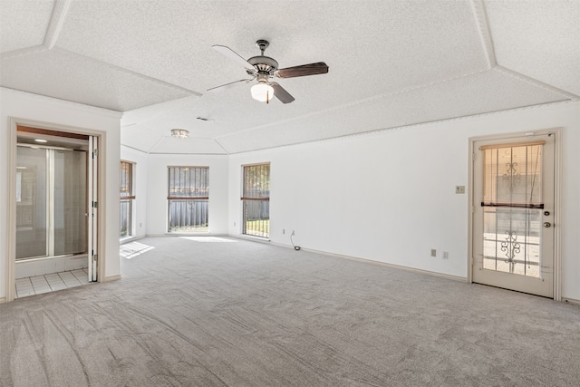 carpeted empty room with ceiling fan and a textured ceiling