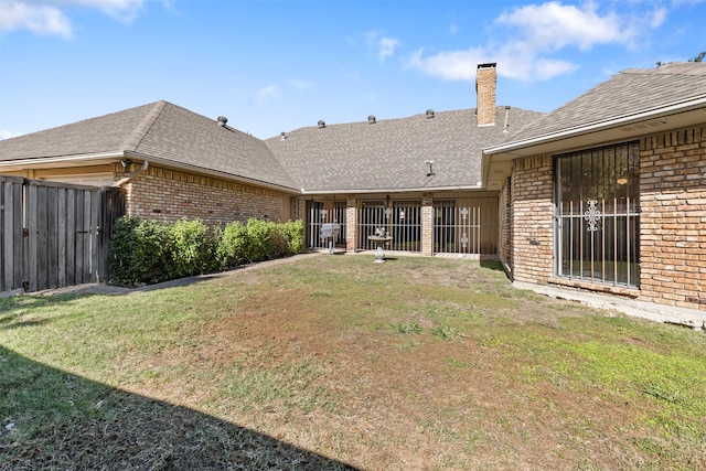 back of property featuring a lawn