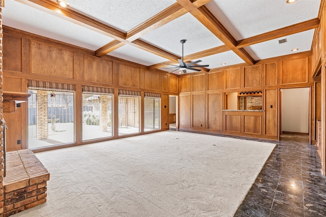 unfurnished living room featuring beam ceiling, ceiling fan, and coffered ceiling