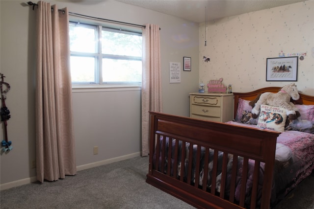 carpeted bedroom with wallpapered walls and baseboards