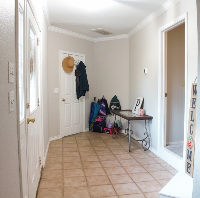 entryway featuring crown molding and light tile patterned floors