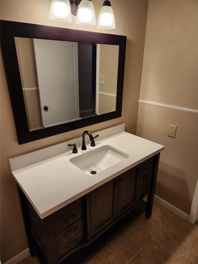 bathroom featuring tile patterned flooring and vanity