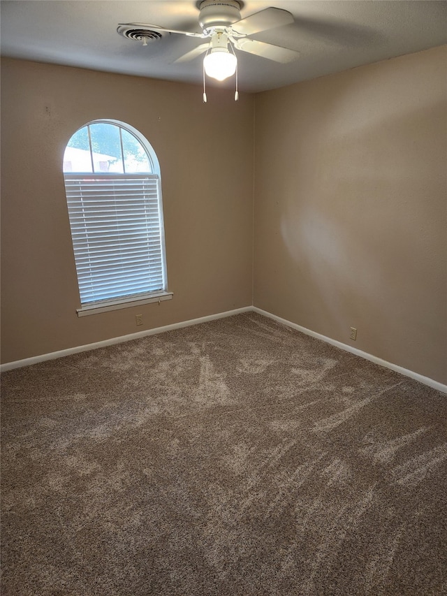 spare room with ceiling fan and carpet floors