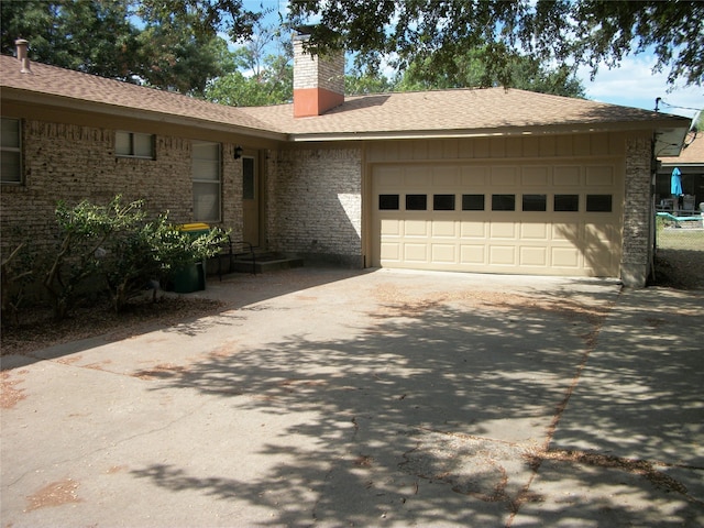 ranch-style home featuring a garage