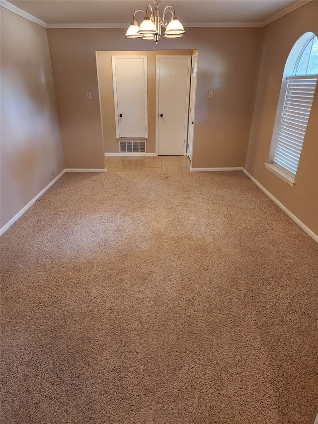 carpeted spare room featuring crown molding and a chandelier