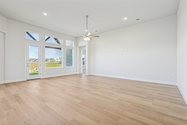 unfurnished living room featuring ceiling fan and light wood-type flooring