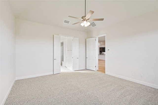 unfurnished bedroom with ceiling fan and light colored carpet