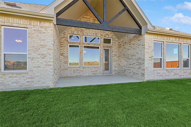 property entrance with a patio area and a yard