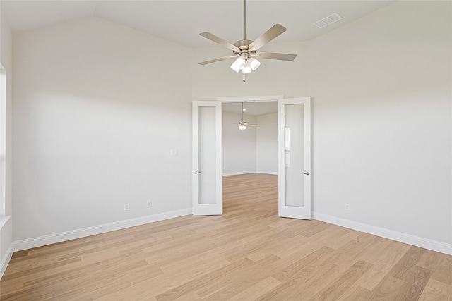 unfurnished room with ceiling fan, lofted ceiling, french doors, and light hardwood / wood-style flooring