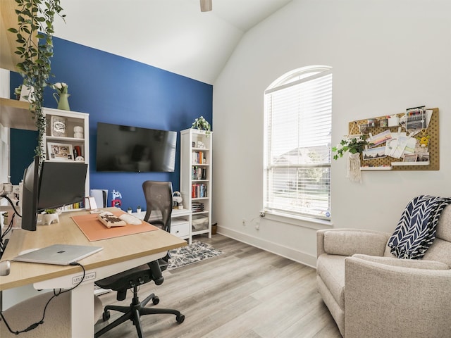 office featuring vaulted ceiling and hardwood / wood-style flooring