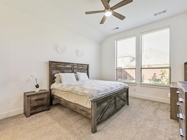 carpeted bedroom with ceiling fan and vaulted ceiling