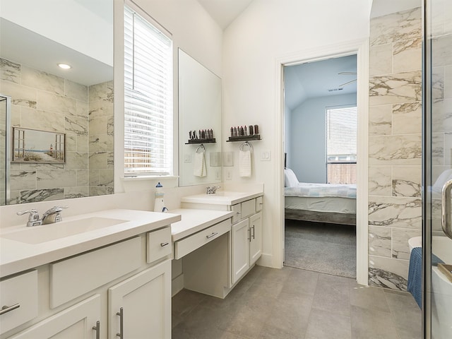 bathroom with vanity, lofted ceiling, plenty of natural light, and an enclosed shower