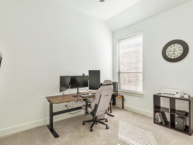 office area featuring lofted ceiling and light carpet