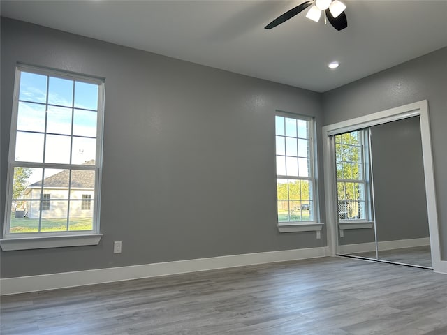 unfurnished room with light hardwood / wood-style flooring and ceiling fan