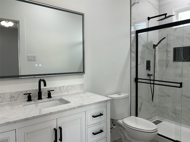 bathroom with vanity, toilet, and a shower with door