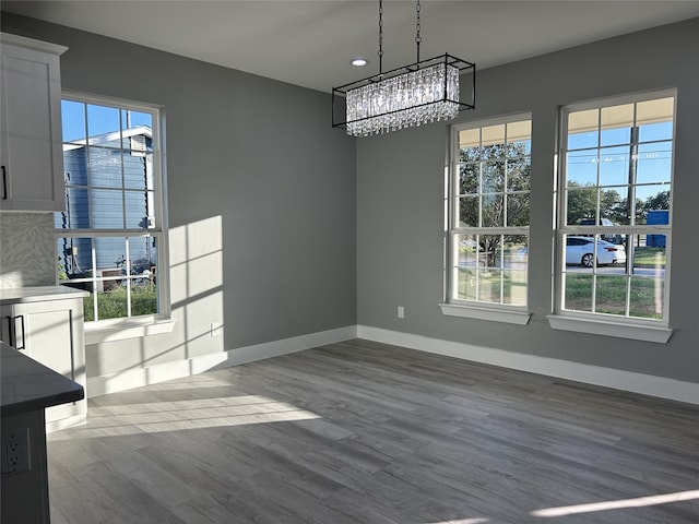 entryway with wood-type flooring and a towering ceiling