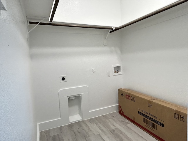 clothes washing area with gas dryer hookup, hookup for a washing machine, electric dryer hookup, and light wood-type flooring