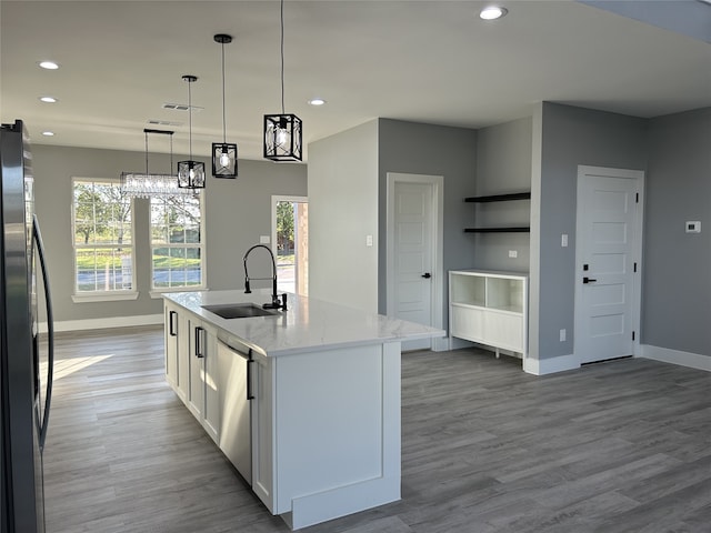 unfurnished dining area with wood-type flooring, an inviting chandelier, and plenty of natural light