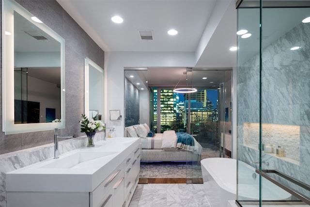 bathroom with vanity and separate shower and tub