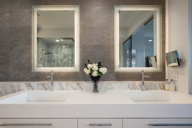 bathroom featuring tile walls, a shower with shower door, and vanity