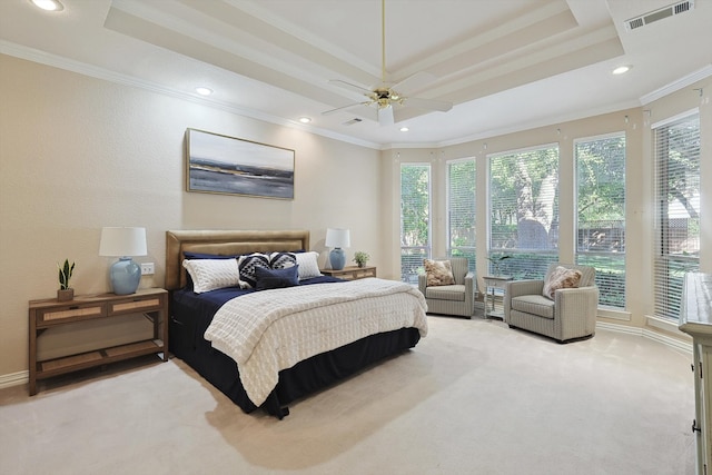 bedroom featuring ceiling fan, a raised ceiling, crown molding, and light carpet