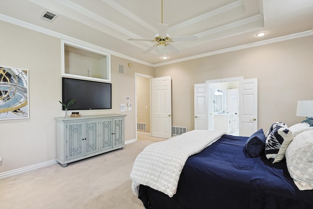 carpeted bedroom featuring ornamental molding, a tray ceiling, ceiling fan, and ensuite bath