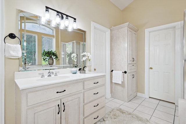 bathroom featuring tile patterned flooring, vanity, and plus walk in shower