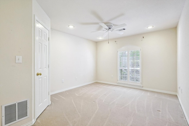 empty room with ceiling fan and light colored carpet