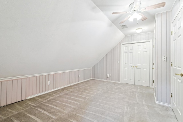 additional living space with light carpet, vaulted ceiling, and ceiling fan