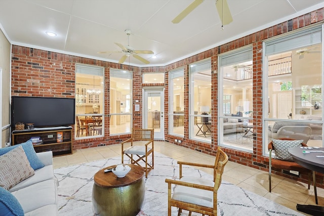 sunroom / solarium featuring ceiling fan